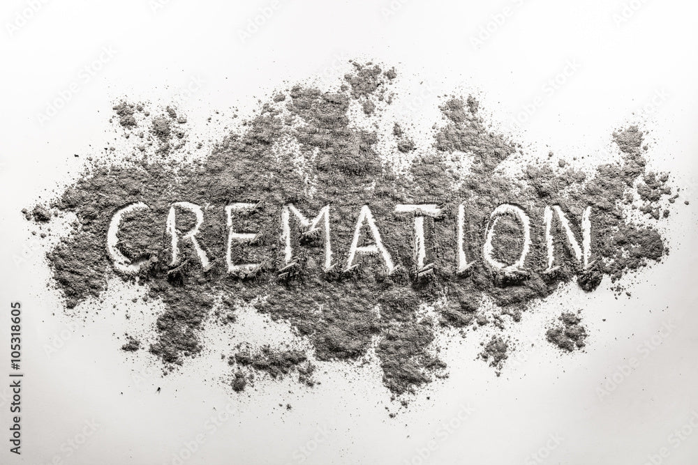 Cremation ashes arranged on white background with 'Cremation' written in center, memorial concept